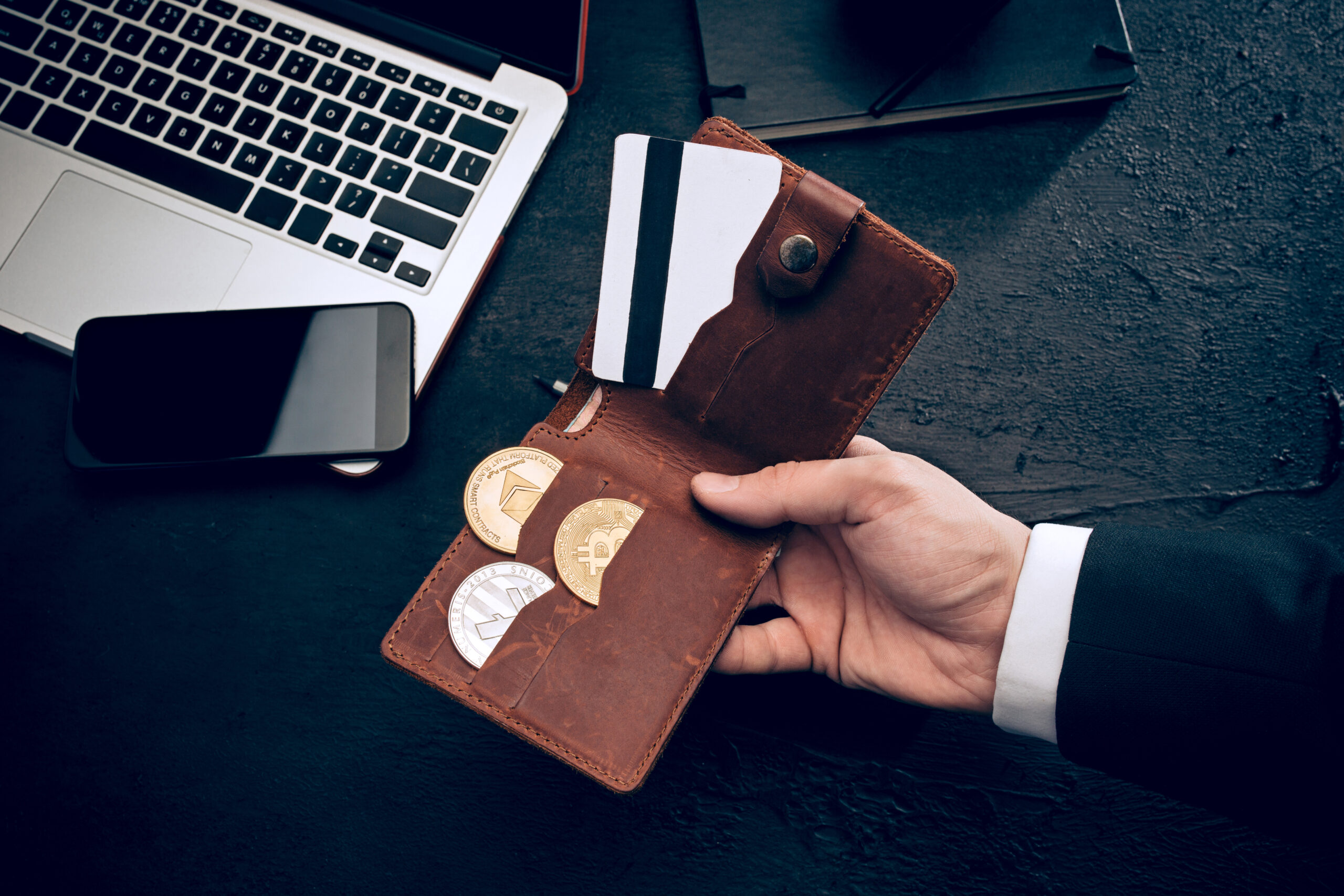 The golden bitcoin in mail hands The golden bitcoin and purse in male hands. Cryptocurrency bitcoin coins. Litecoin, Bitcoin, Ethereum, e-commerce, busibess, finance concept. crypto currency symbol. virtual electronic money concepts